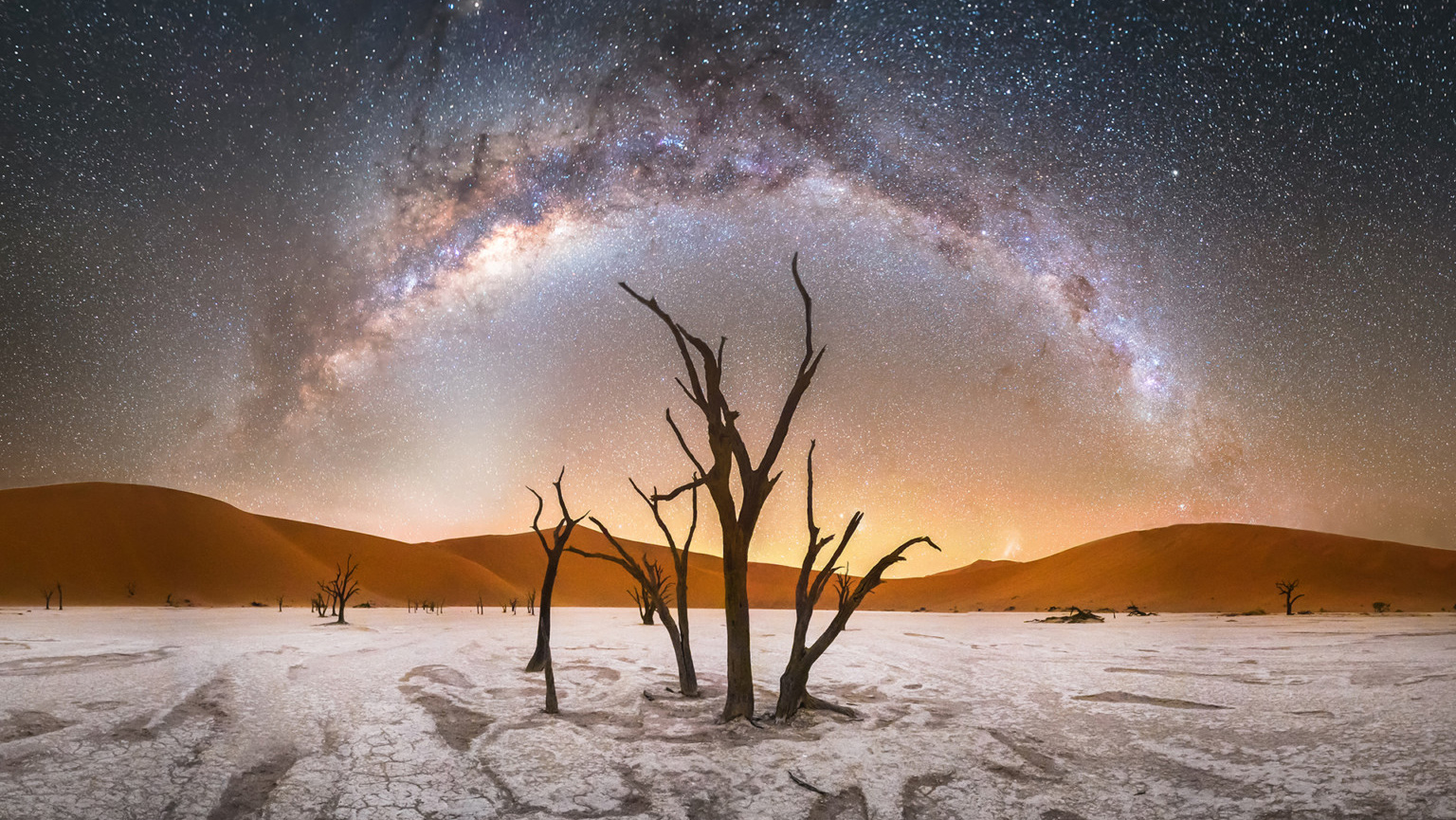 Astronomy Winner October - A leafless tree standing in a desert with stars arching over it
