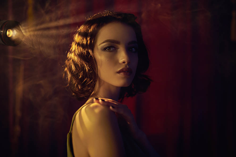 Portrait Winner November - A girl in a dark theater room with dramatic lighting