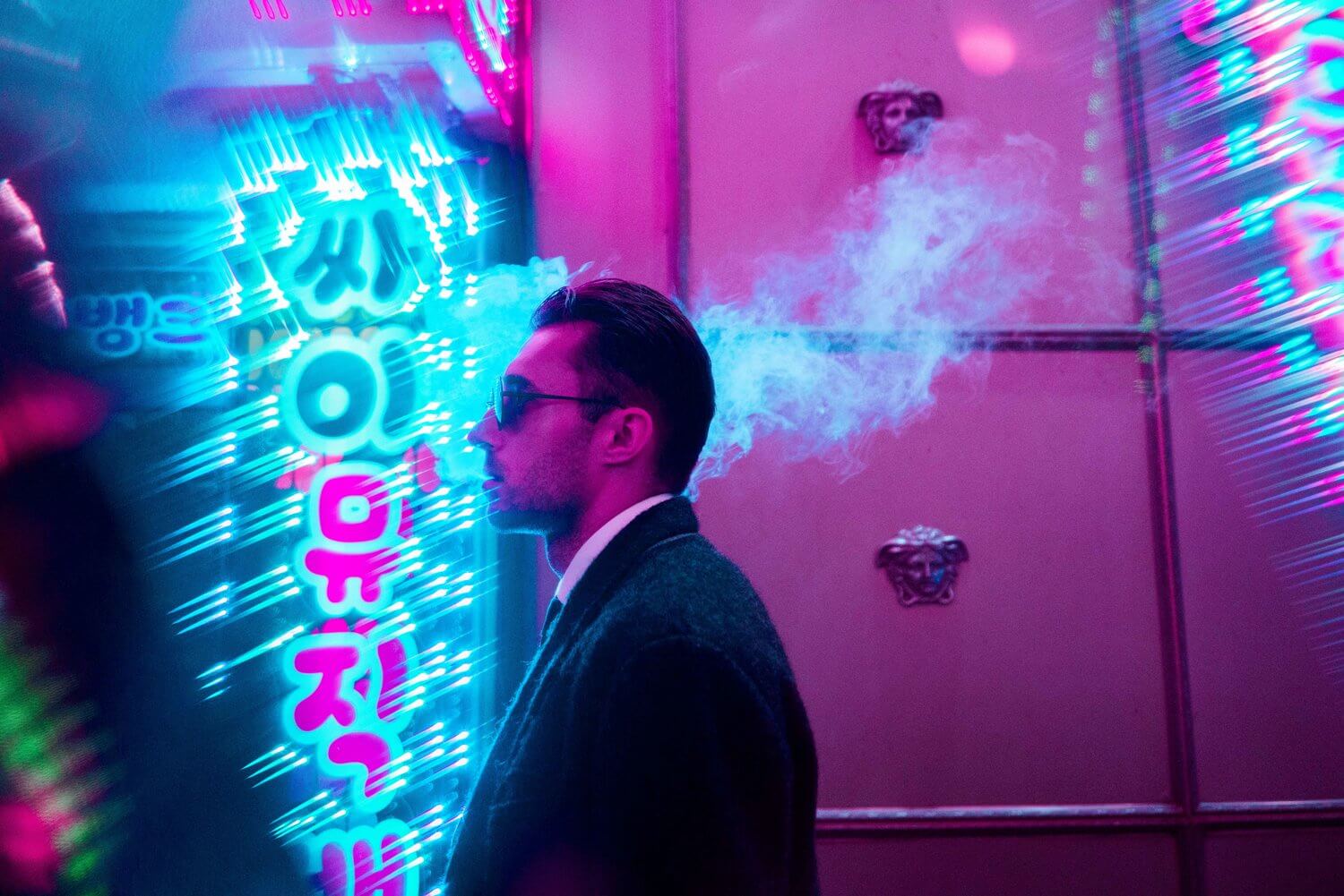Portrait Winner April - A man in a suit with a profile shot of him walking through a neon street in Korea
