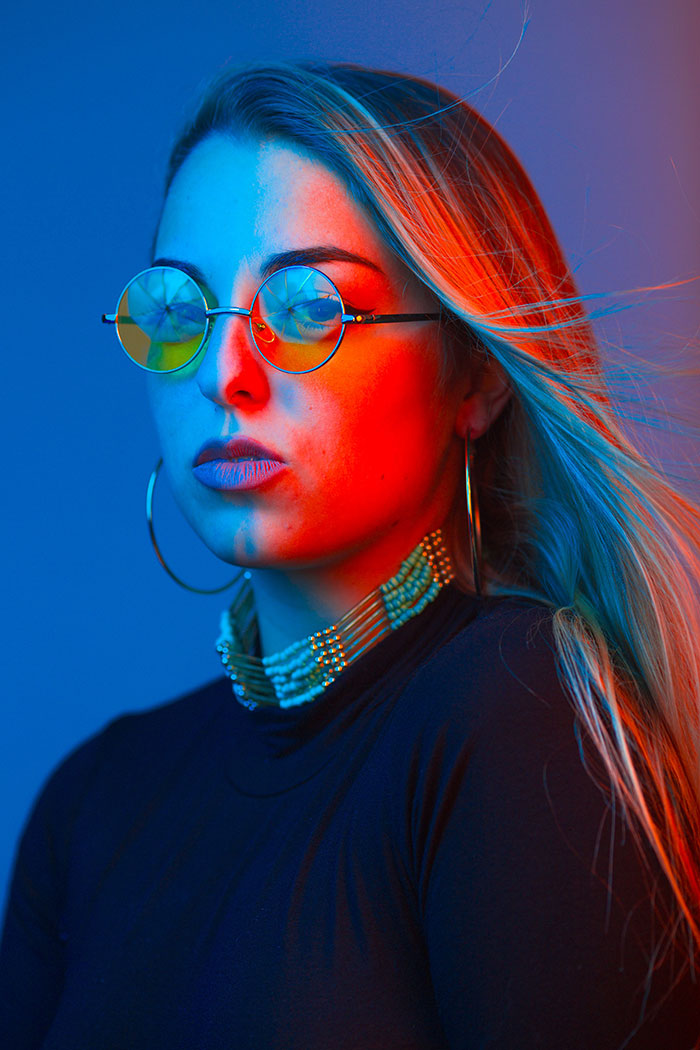 Portrait Winner March - A person with vibrant red and blue colors lighting on their face